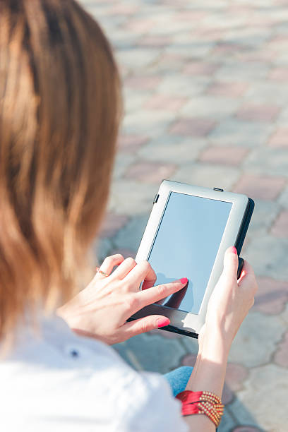 istock smiling girl touching tablet screen 524719442