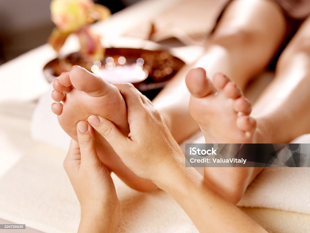 Massage of human foot in spa salon Massage of human foot in spa salon - Soft focus image Massaging Stock Photo