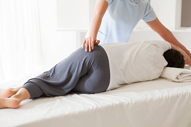 istock Masseuse massaging a lying woman 524722178