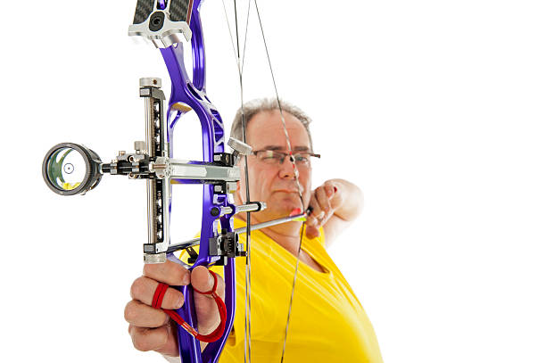 istock Man shooting with bow an arrow in close up 524722229