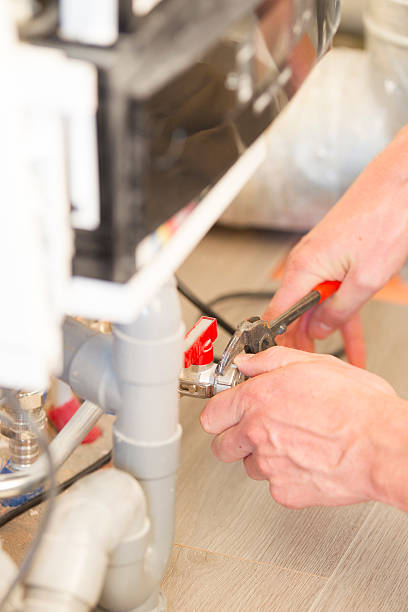 istock Plumber repairing a heater in house, servicing 524722515