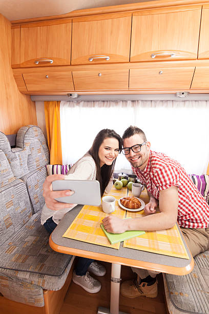 istock Cheerful young couple making selfie inside of a camper van 524722744