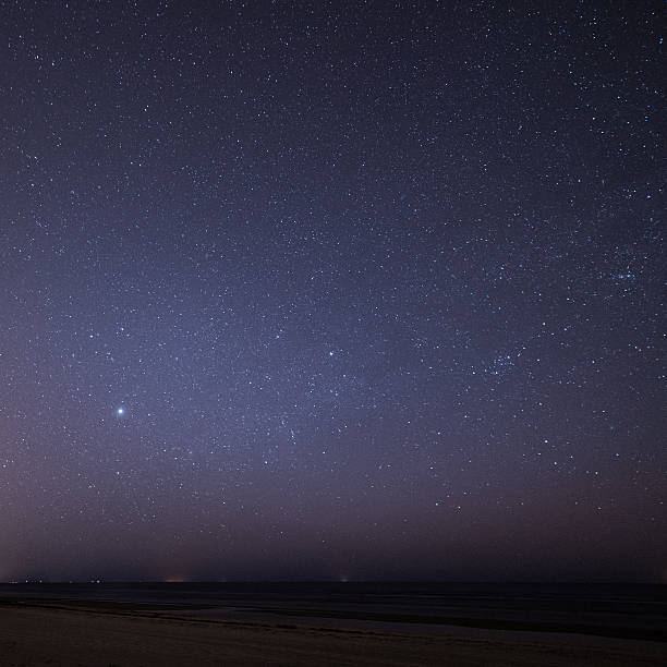 istock night sky with stars on the beach. space view. 524722885