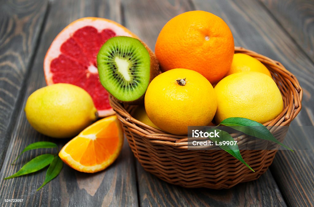 Citrus fruits Basket  of Citrus Fruits on a wooden background Basket Stock Photo