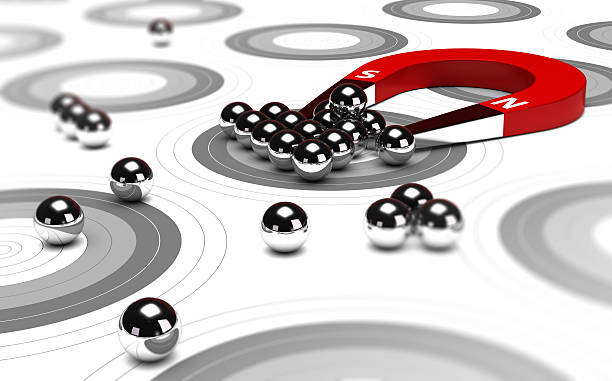 Inbound Marketing Horseshoe magnet attracting metal balls in the center of a grey target. Image concept of inbound marketing or advertising. retain stock pictures, royalty-free photos & images