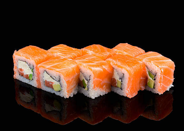 istock Japanese cuisine. Salmon sushi roll over black background. 524724488