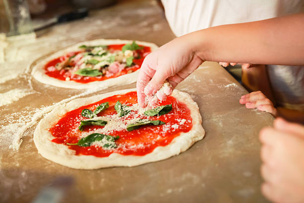 istock Preparing Pizza Margherita, cook adds cheese 524727902