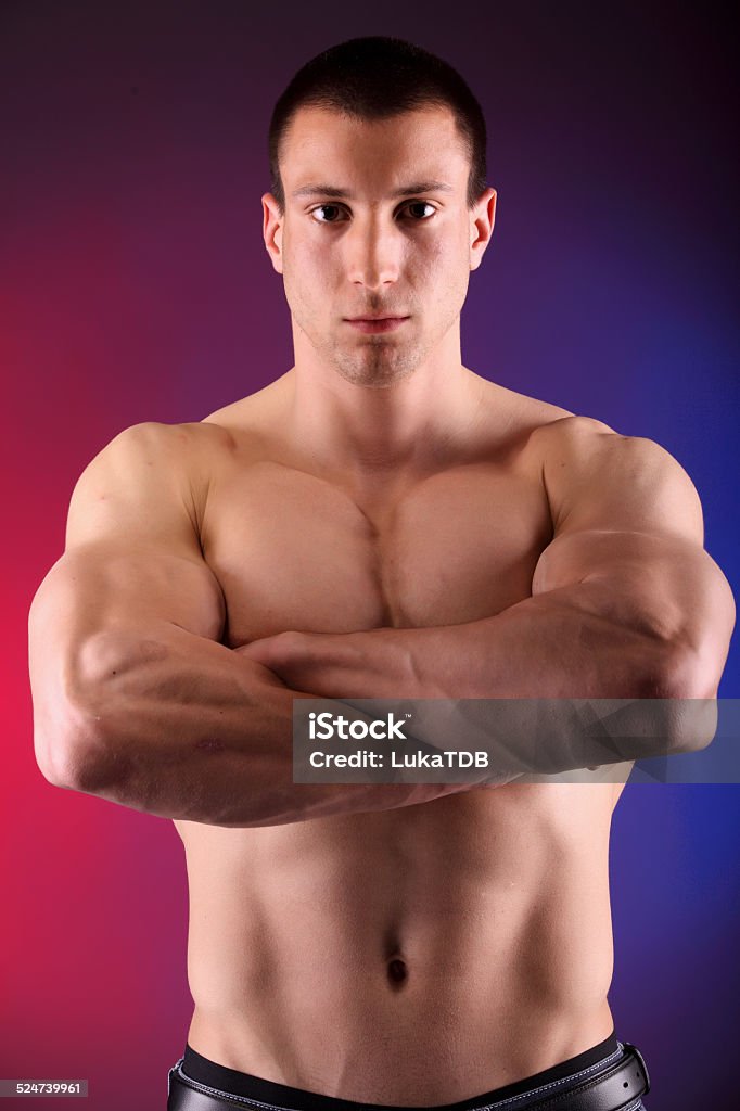 Young man showing his muscles Active Lifestyle Stock Photo