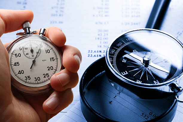 istock Hand holding stopwatch on budget numbers 524740605