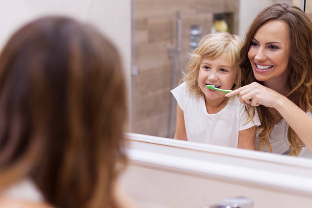 istock Morning lesson of brushing teeth with mommy 524742403