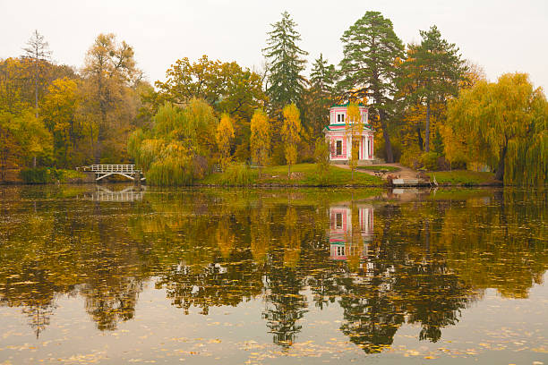 istock Ancient pink pavilion on autumn park lake 524742587