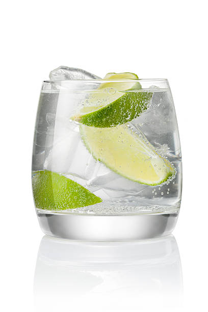 Cocktail with ice and lime Cocktail with soda water, vodka or rum, ice and lime slice isolated on white background tonic water stock pictures, royalty-free photos & images