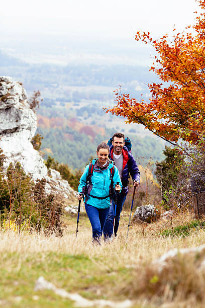 幸せなカップルのハイキング - nordic walking walking relaxation exercise women ストックフォトと画像