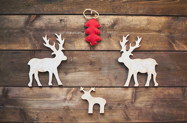 istock Wooden deer and red firtree 524745249