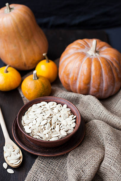 istock Bowl with toasted pumpkin seeds and wooden spoon 524745865