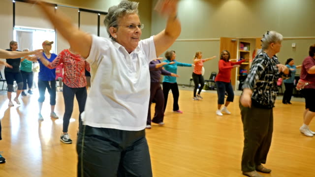 Diverse group of Senior women dancing during exercise class