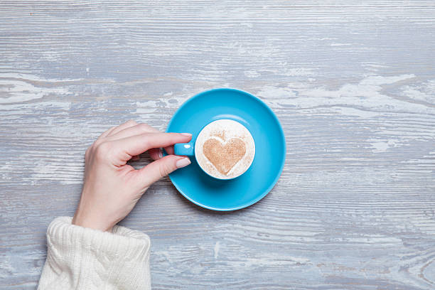 istock Female hand holding cup of coffee. 524773285