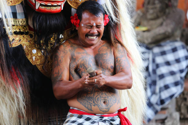 Denpasar, Indonesia - August 22, 2014: Barong and a kris-wielding dancer in a Barong ceremony in Bali.