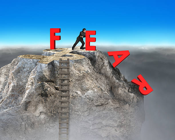 istock businessman pushing red fear word down with dollar sign 524778491