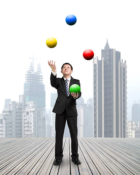 istock businessman throwing and catching colorful balls 524778605