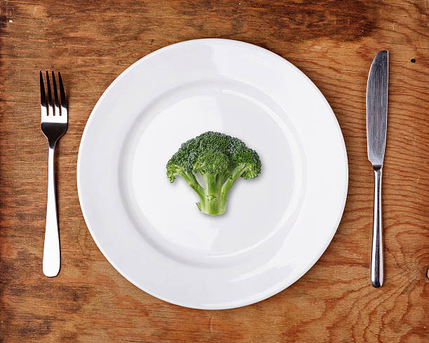 istock Knife, Fork and plate with broccoli on wooden table. 524779013