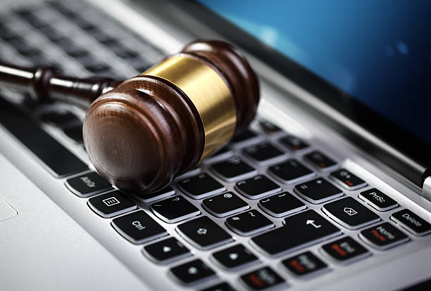 Justice gavel and laptop computer keyboard Gavel on laptop computer keyboard concept for online internet auction or legal assistance e auction stock pictures, royalty-free photos & images