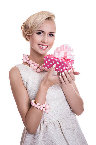 istock Young beautiful woman holding small gift box with ribbon 524817103