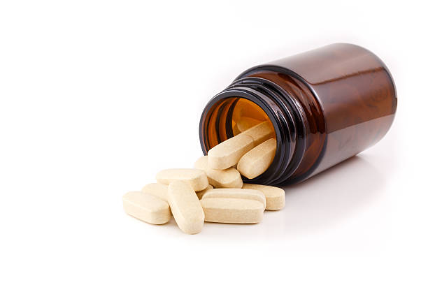 istock Vitamin pills view brown bottle on side 524817751