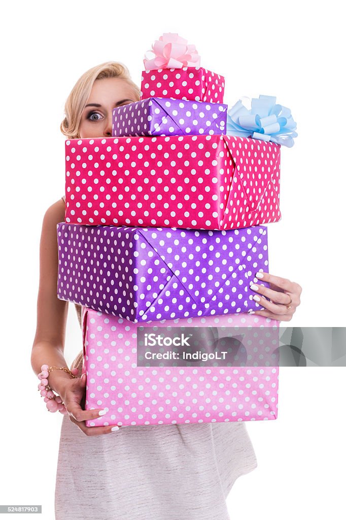 Beautiful blonde woman looking through colorful gift boxes Beautiful blonde woman looking through colorful gift boxes. Studio portrait isolated over white background Adult Stock Photo