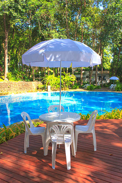 white plastic garden furniture table and chairs summer evening - stock photo