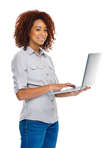A beautiful young  woman holding a laptop against a white background