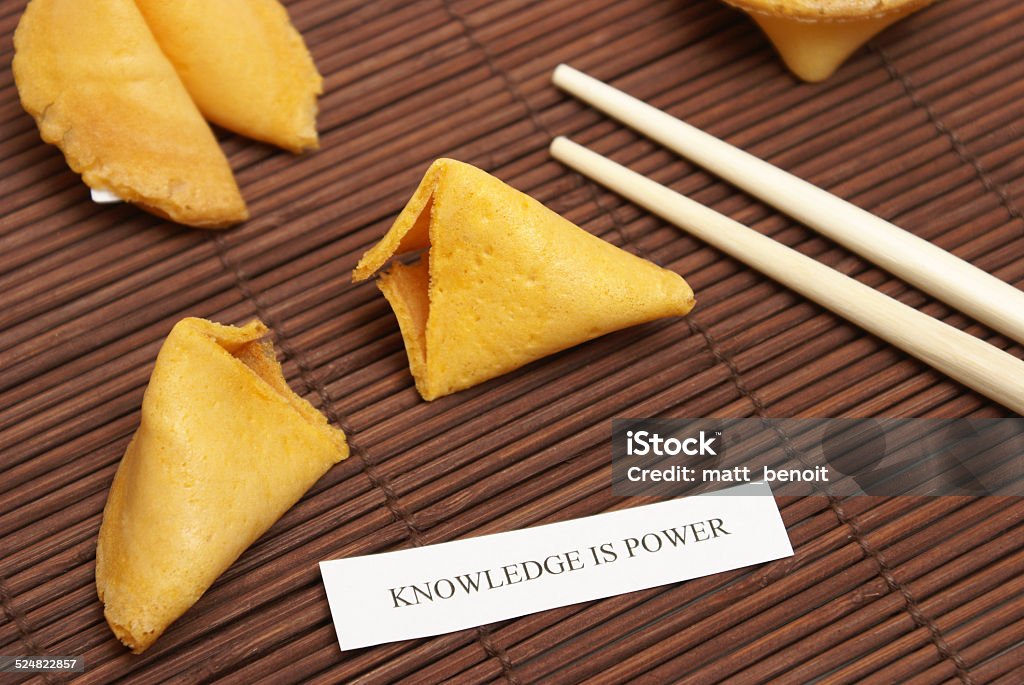 Fortune Cookie of Knowledge A cracked open fortune cookie stating that knowledge is power. Aspirations Stock Photo