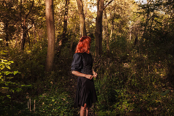 istock Young redhead woman in the woods 524856345