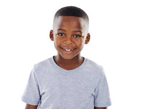 Studio shot of a happy little boy in casual wear posing against a white background