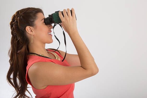 istock Attractive woman with binoculars 524857329