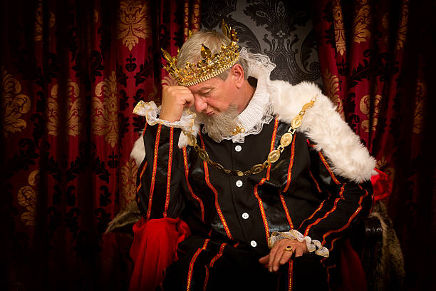 Problems of a king Pensive and worried king sitting on his throne king royal person stock pictures, royalty-free photos & images