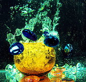 yellow glass transparent ball with storm inside water