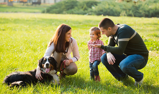 Beautiful family spending time together with their dog