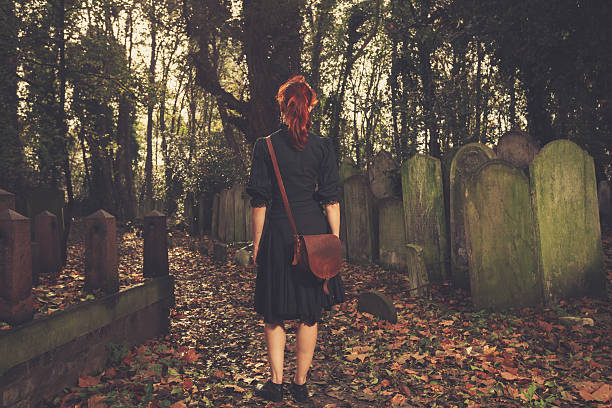 istock Woman walking amongst tombstones 524859355