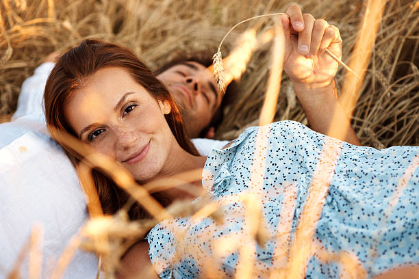 Cropped shot of an attractive young couple lying in a wheat field
