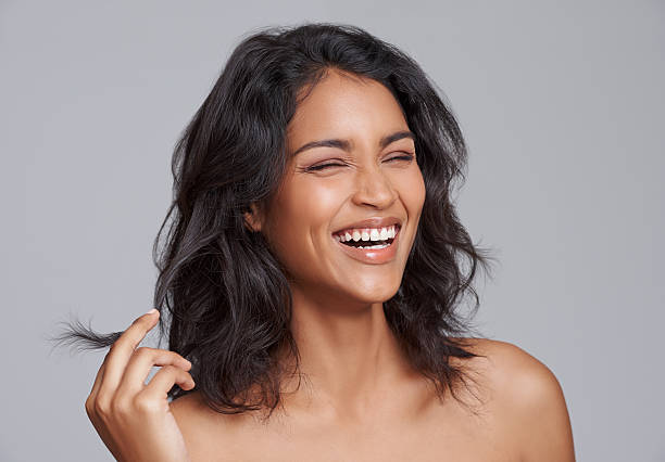 Beauty gets the attention, personality gets the heart Shot of a beautiful young woman standing with her eyes closed indian woman laughing stock pictures, royalty-free photos & images