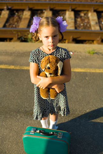 Retro portrait of a five year old girl on a railway platform