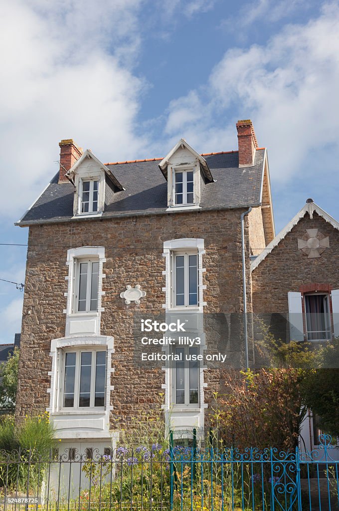 Villa in Saint-Malo Saint-Malo, France - July 7, 2011: Villa built with traditional granite stones and french doors in Rotheneuf, a suburb of Saini-Malo. Rotheneuf is a seaside resort and famous for its sculpted rocks. Abandoned Stock Photo