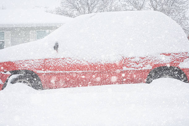 istock Red car buried in snow during winter snowstorm 524879857