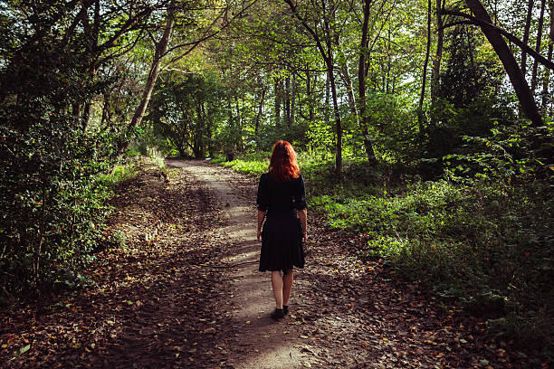 istock Young woman walking in forest 524879935