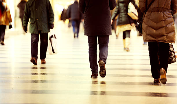istock Motion blurred customers walking in shopping mall 524880423