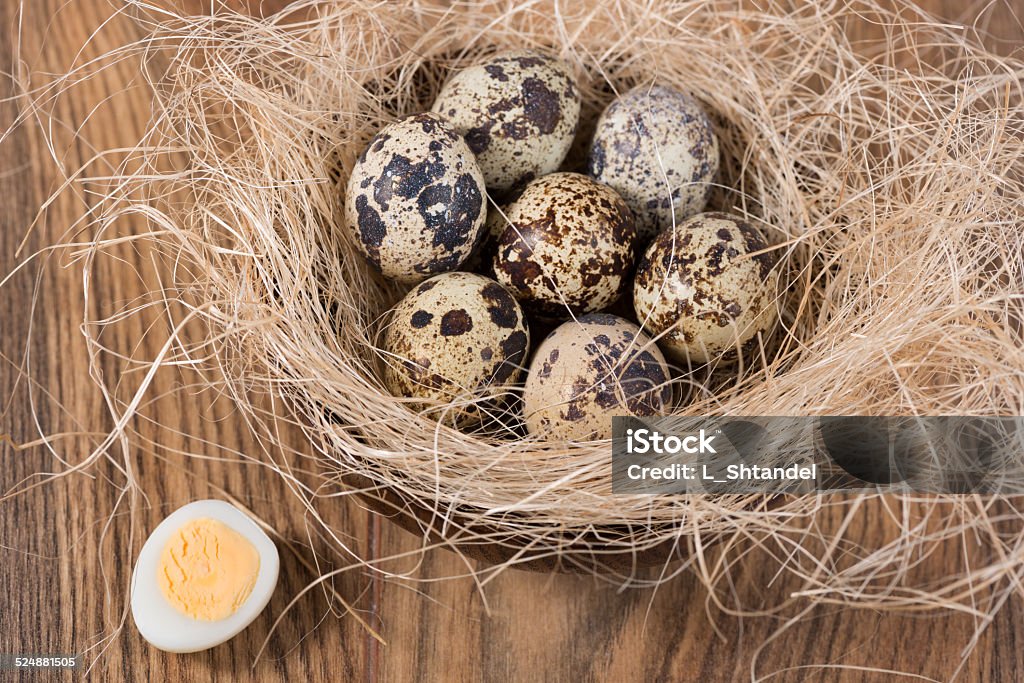 quail eggs lying in a wooden table quail eggs lying in a wooden bowl on the table Animal Stock Photo