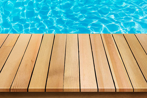 istock wood table top  with blue sea background 524882052