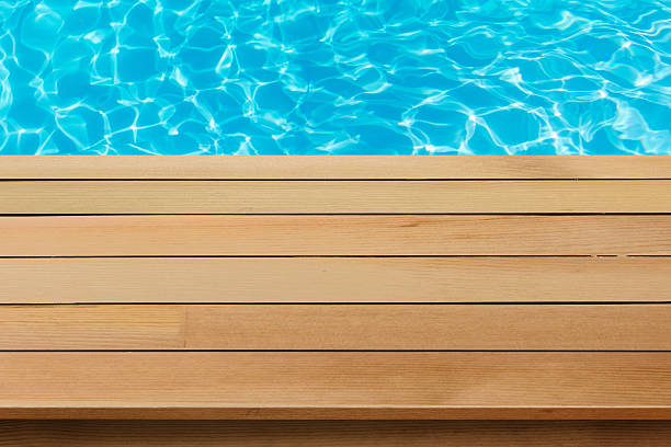 istock wood table top  with blue sea background 524882236