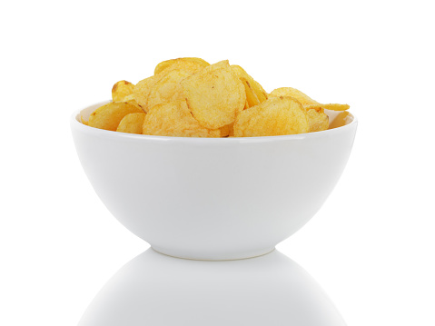 heap of potato chips with paprika, isolated on white